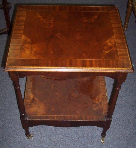 Appraisal: A mahogany two-tier table with cross banded border cm wide