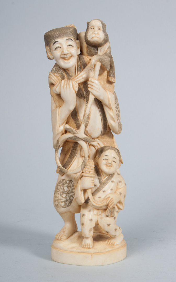 Appraisal: Japanese carved ivory figural group modeled as man with young