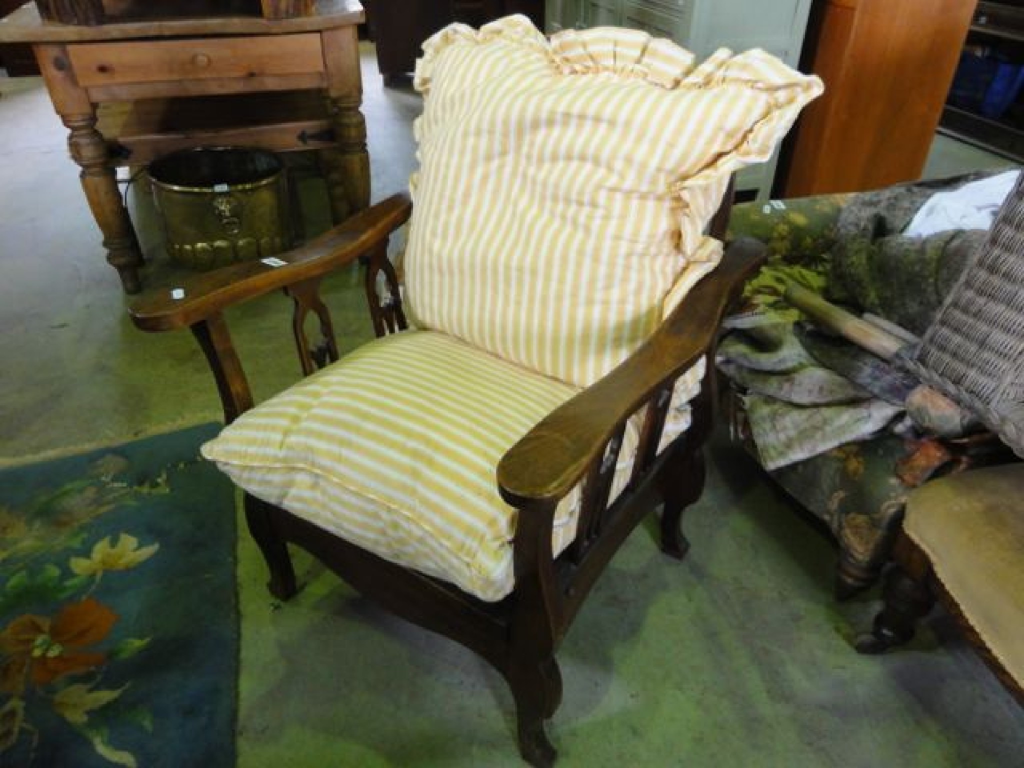 Appraisal: An early th century reclining chair the hooped back with