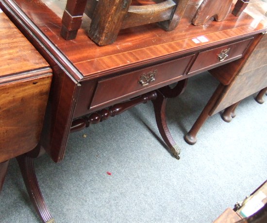 Appraisal: A Regency style sofa table raised on lyre shape supports