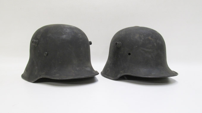 Appraisal: TWO GERMAN MODEL MILITARY HELMETS both steel helmets with folded