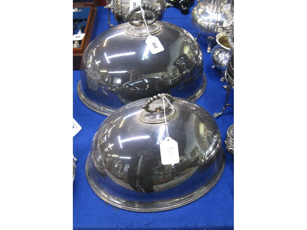 Appraisal: Graduated pair of silver plated meat dish covers