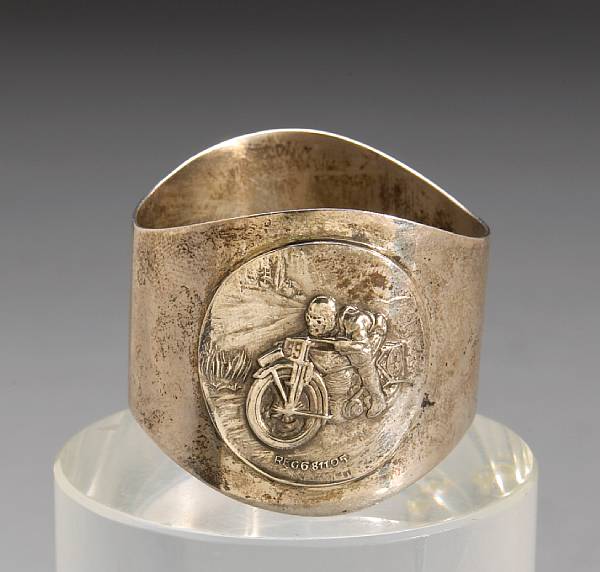 Appraisal: A Hallmarked sterling silver napkin ring featuring motorcyclist at speed