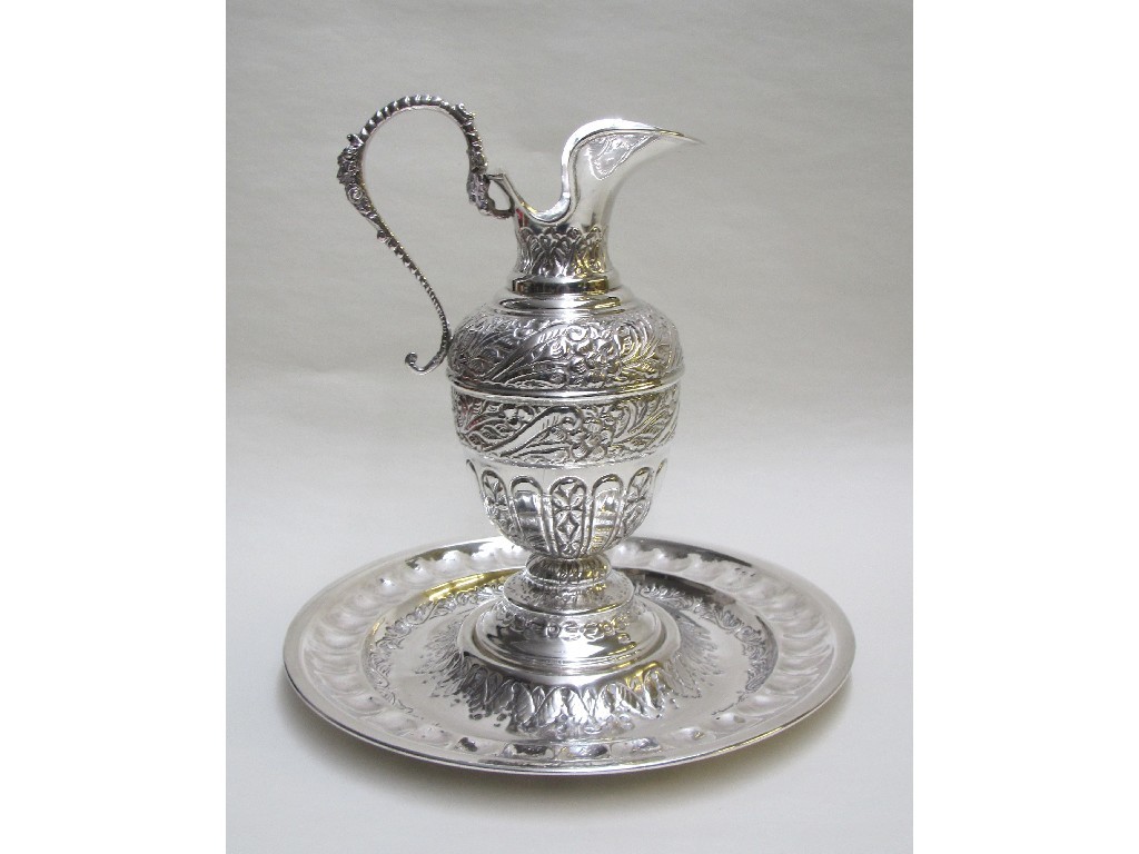 Appraisal: A continental silver ewer and stand embossed with foliage scrolls