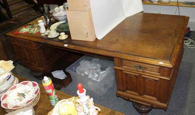 Appraisal: A LARGE WALNUT OFFICE DESK of pedestal form fitted with