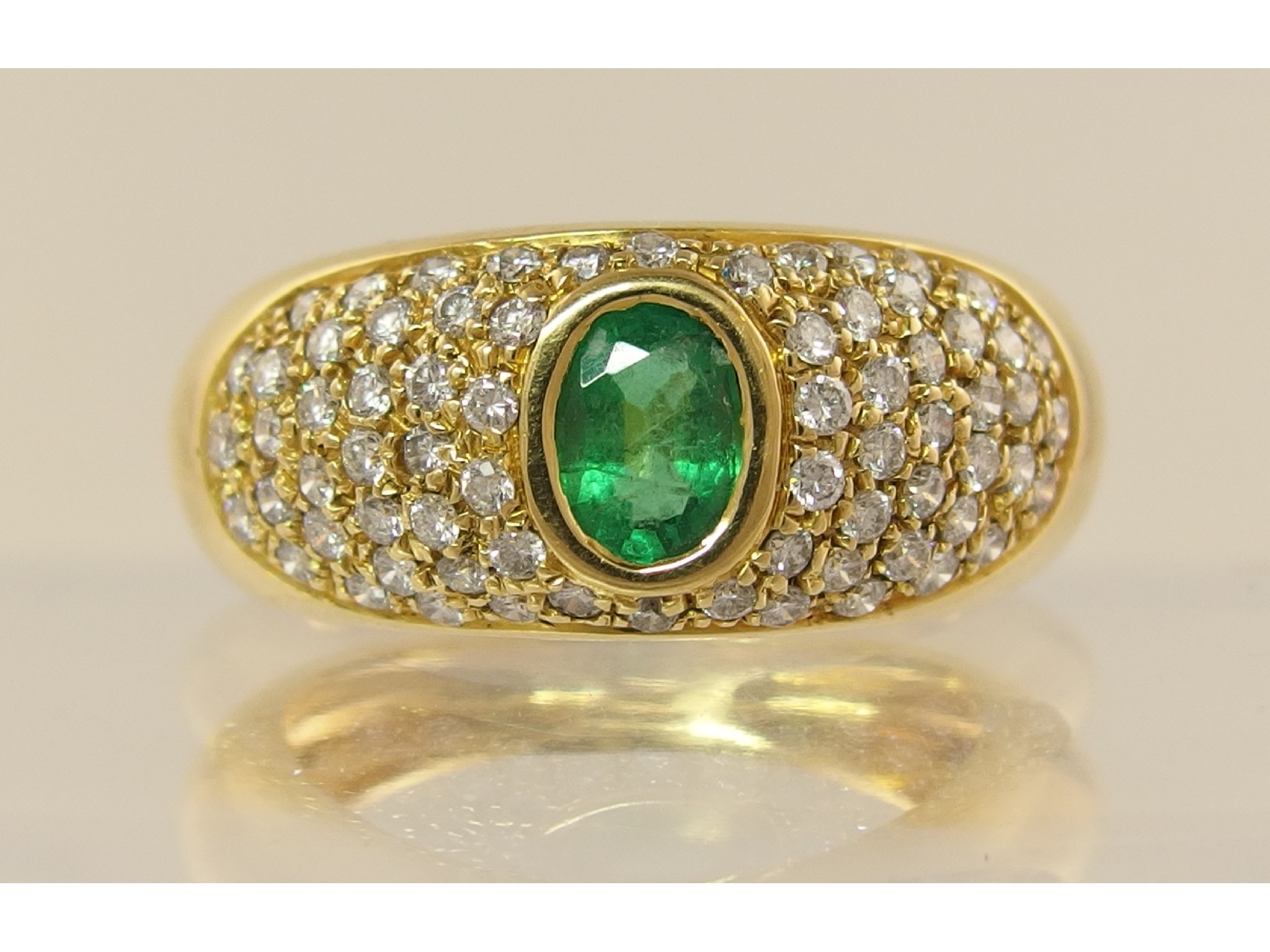 Appraisal: An ct yellow gold emerald and diamond dress ringthe domed