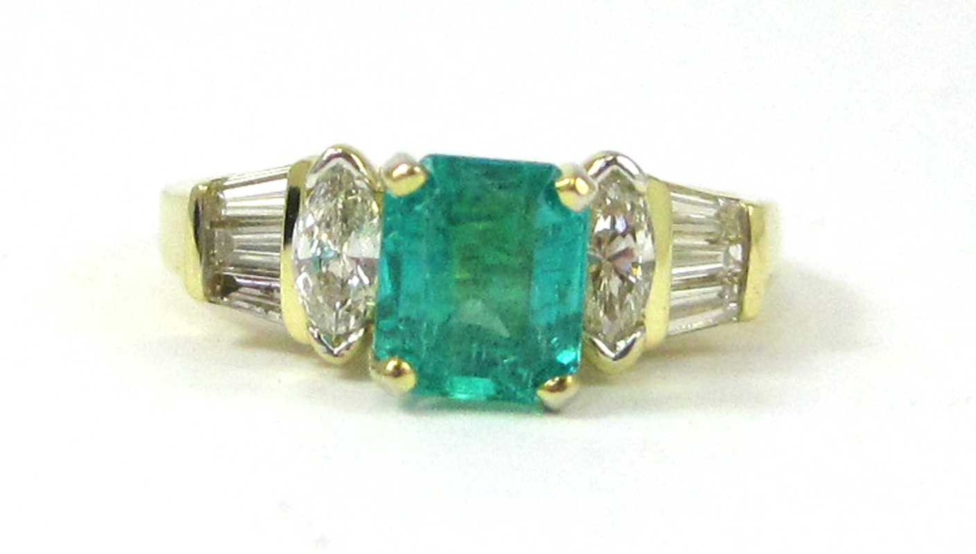 Appraisal: FOURTEEN KARAT GOLD EMERALD AND DIAMOND RING having two marquise-cut