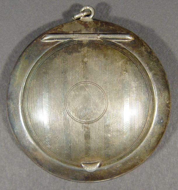 Appraisal: Circular silver compact the engine turned hinged lid enclosing a