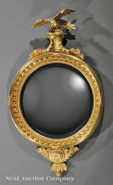 Appraisal: A Regency Carved Giltwood Convex Mirror early th c surmounted