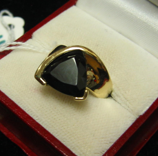 Appraisal: BLACK ONYX AND FOURTEEN KARAT GOLD RING centered is a