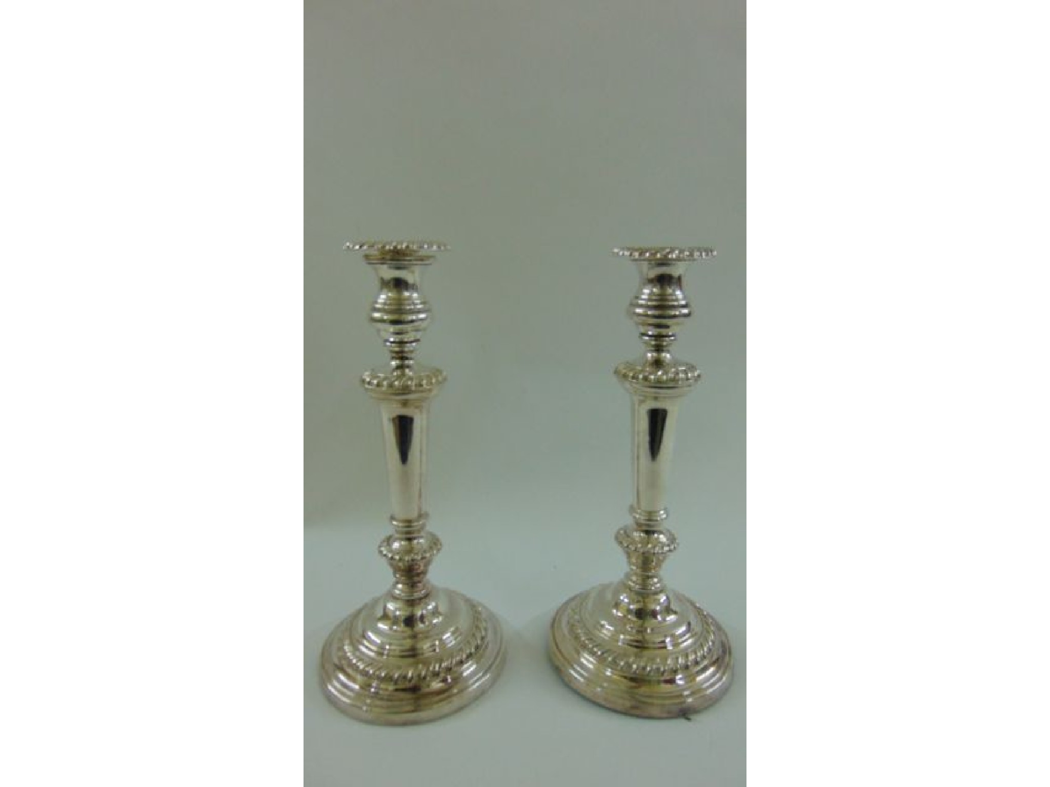 Appraisal: A pair of th century silver on copper candlesticks the