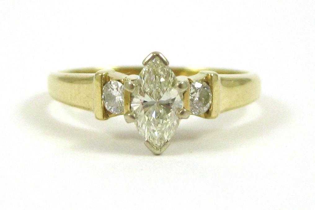 Appraisal: DIAMOND AND FOURTEEN KARAT GOLD RING with two round-cut diamonds