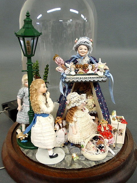 Appraisal: - Glass dome cased miniature setting- bisque doll peddler with