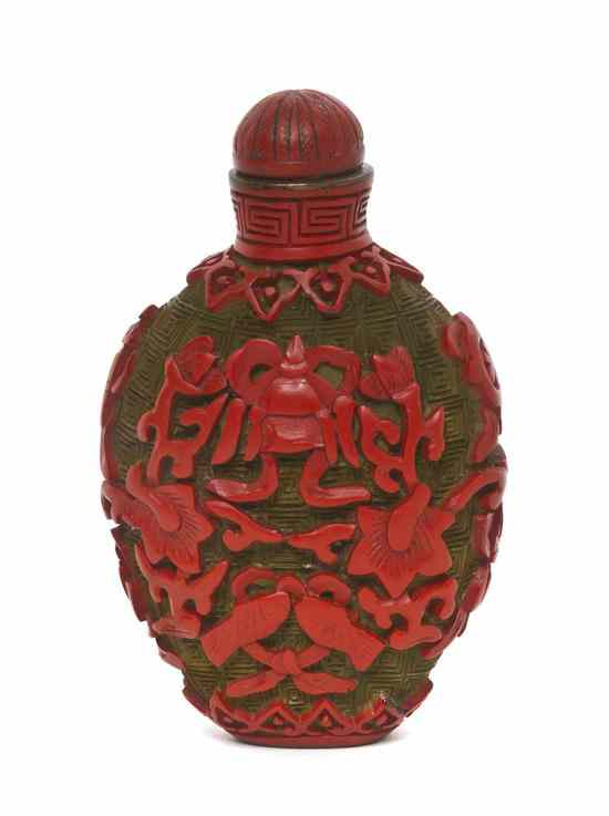 Appraisal: A Chinese Carved Two-Color Lacquer Snuff Bottle of compressed ovoid