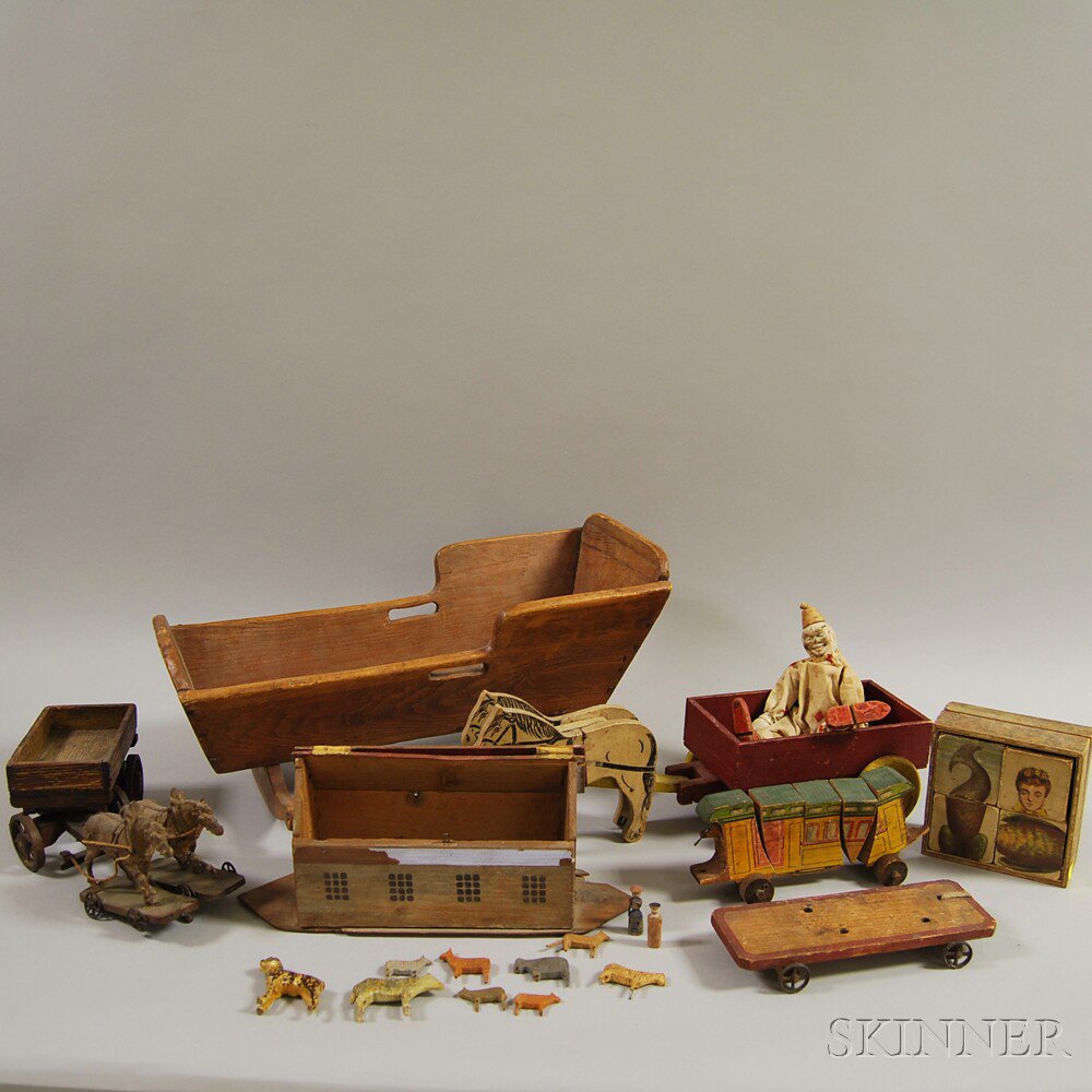 Appraisal: Eight Early Wooden Toys a miniature cradle a painted and