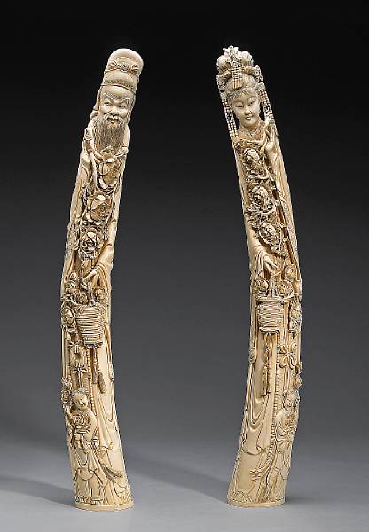 Appraisal: A pair of large tinted ivory Daoist immortals th Century