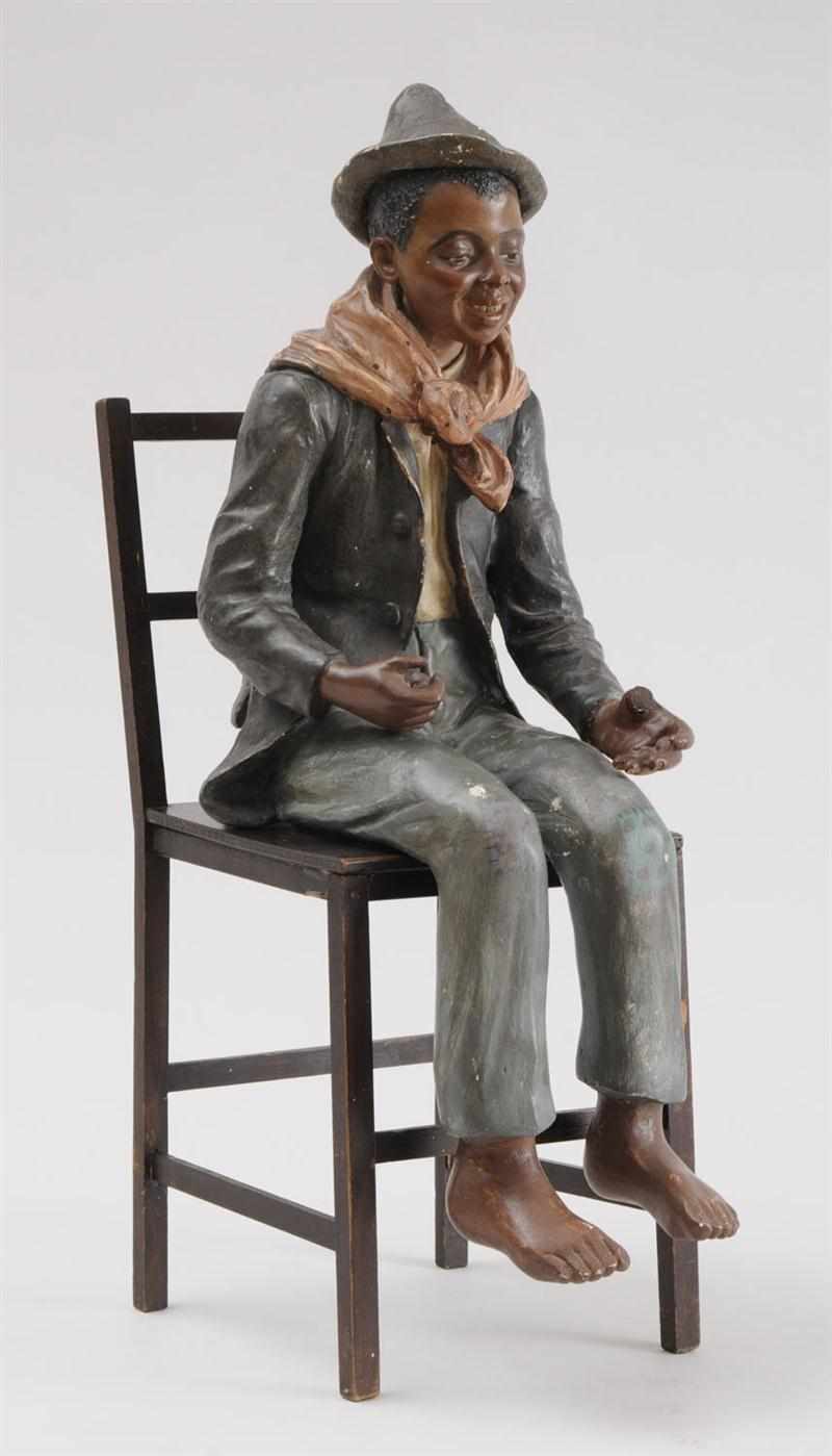 Appraisal: AUSTRIAN PAINTED PLASTER FIGURE OF A SEATED BLACK BOY Marked