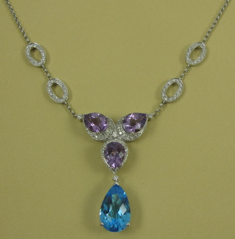 Appraisal: BLUE TOPAZ AND AMETHYST NECKLACE The pendant suspended between two