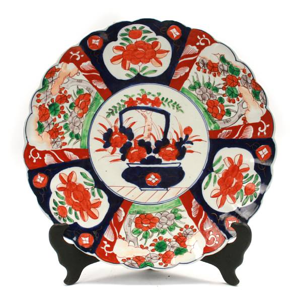 Appraisal: An Imari porcelain foliate rim charger with flower basket central