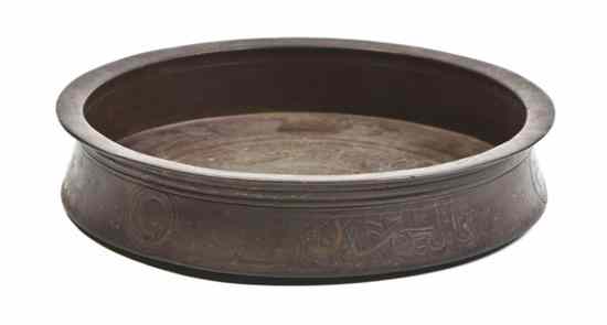 Appraisal: A Middle Eastern Bronze Bowl of low form with inverted