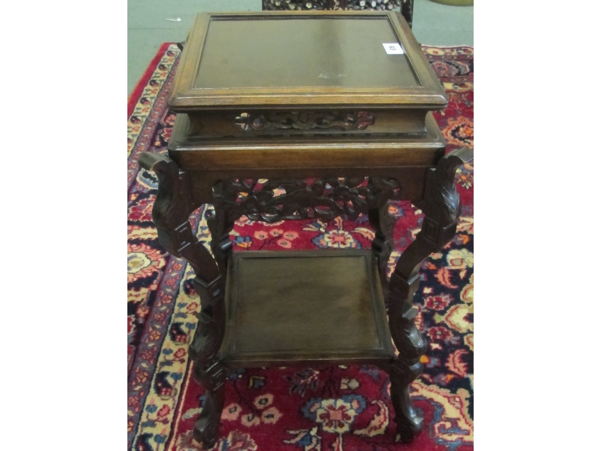 Appraisal: A Chinese style mahogany plant stand with floral carvings