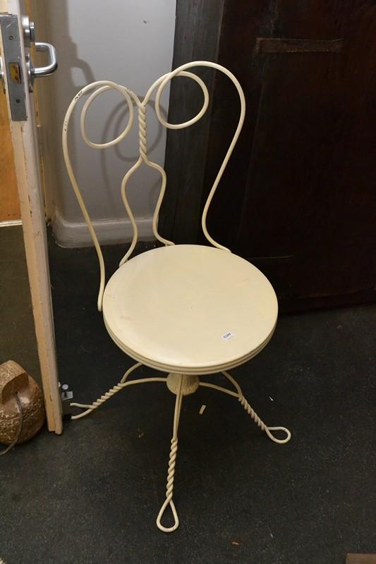 Appraisal: A WHITE WROUGHT IRON CHAIR A WHITE WROUGHT IRON CHAIR