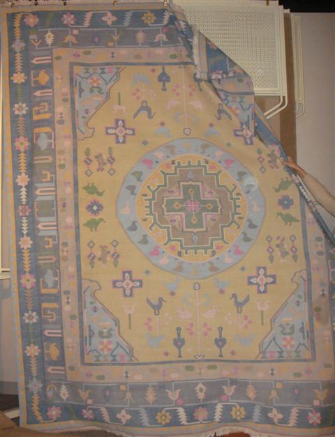 Appraisal: LIGHT MUSTARD AQUA BLUE GREEN AND YELLOW CENTER MEDALLION RUG