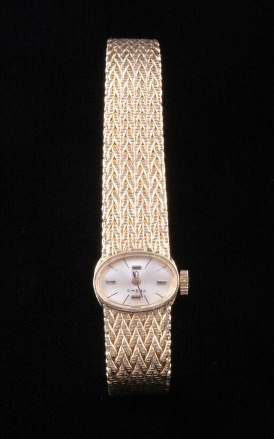 Appraisal: LADY'S K YELLOW GOLD OMEGA WRISTWATCH Oval case with silver