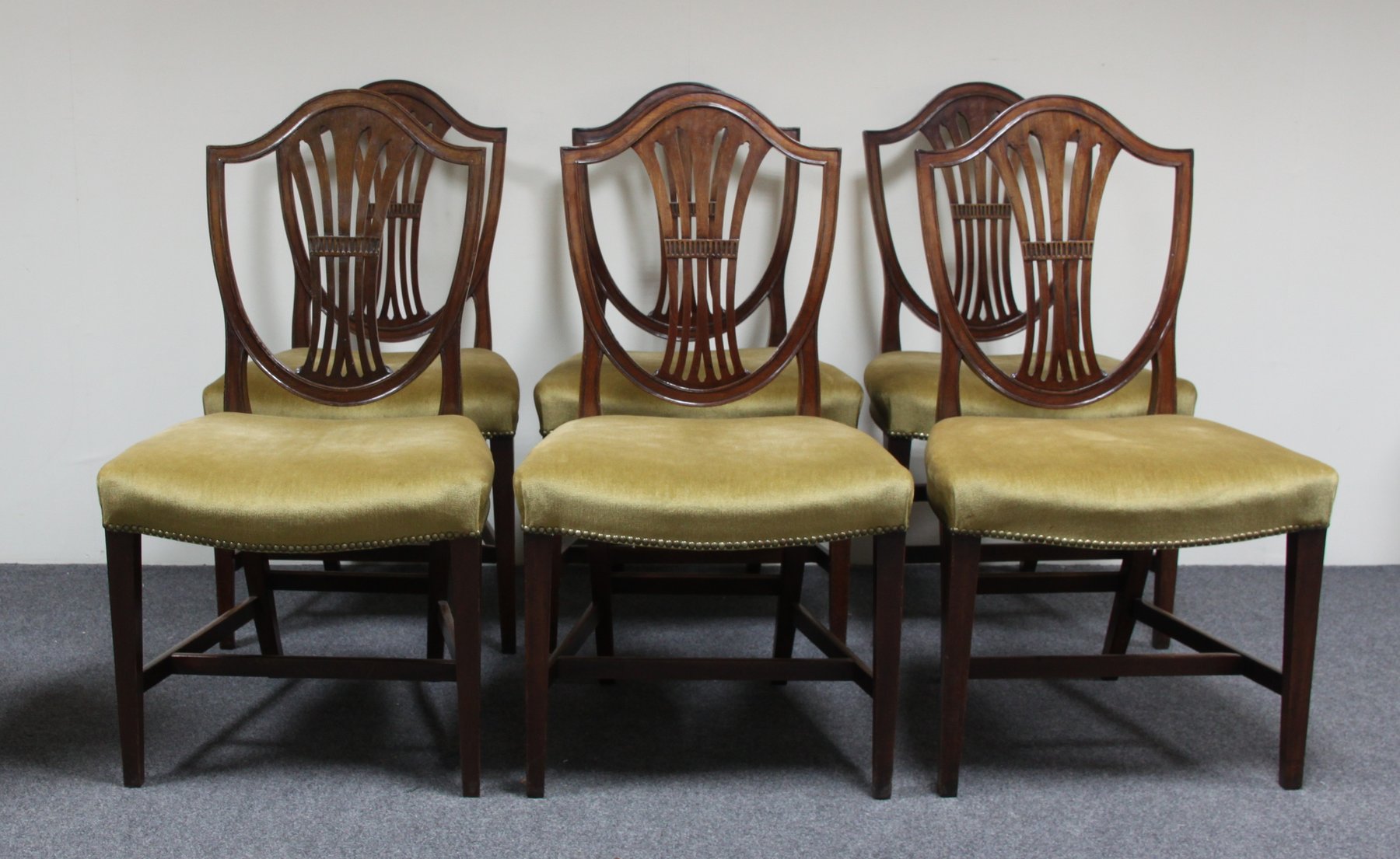 Appraisal: A set of six mahogany shield-back dining chairs with upholstered