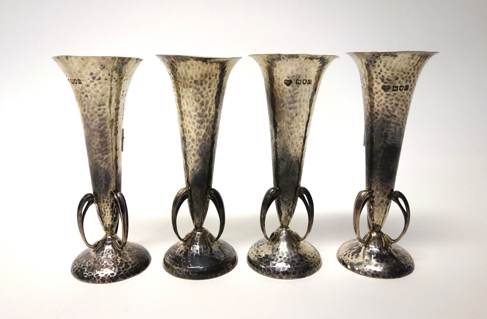 Appraisal: A set of four silver trumpet shaped vases having a