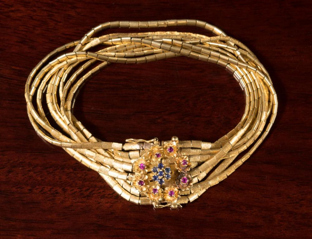 Appraisal: EIGHTEEN KARAT GOLD BRACELET WITH RUBIES AND SAPPHIRES The heavy