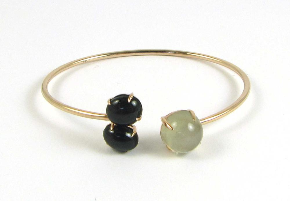 Appraisal: CAT'S EYE GEMSTONE BANGLE Oval black cabochons total cts Round