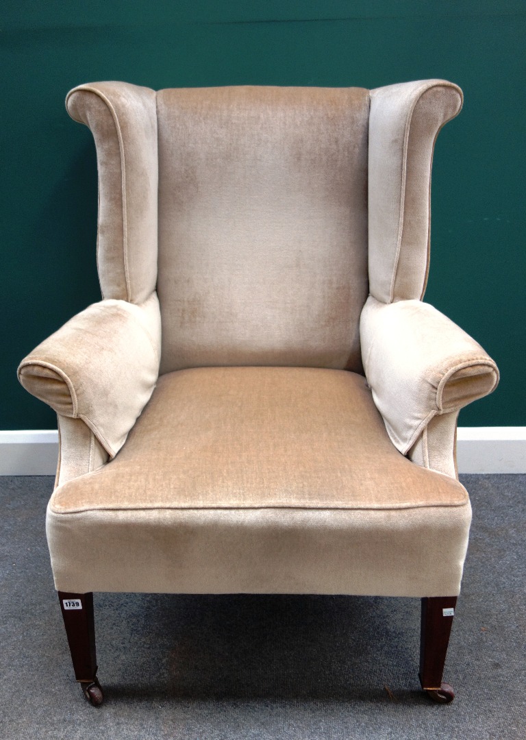 Appraisal: A George III style wingback armchair on tapering square mahogany