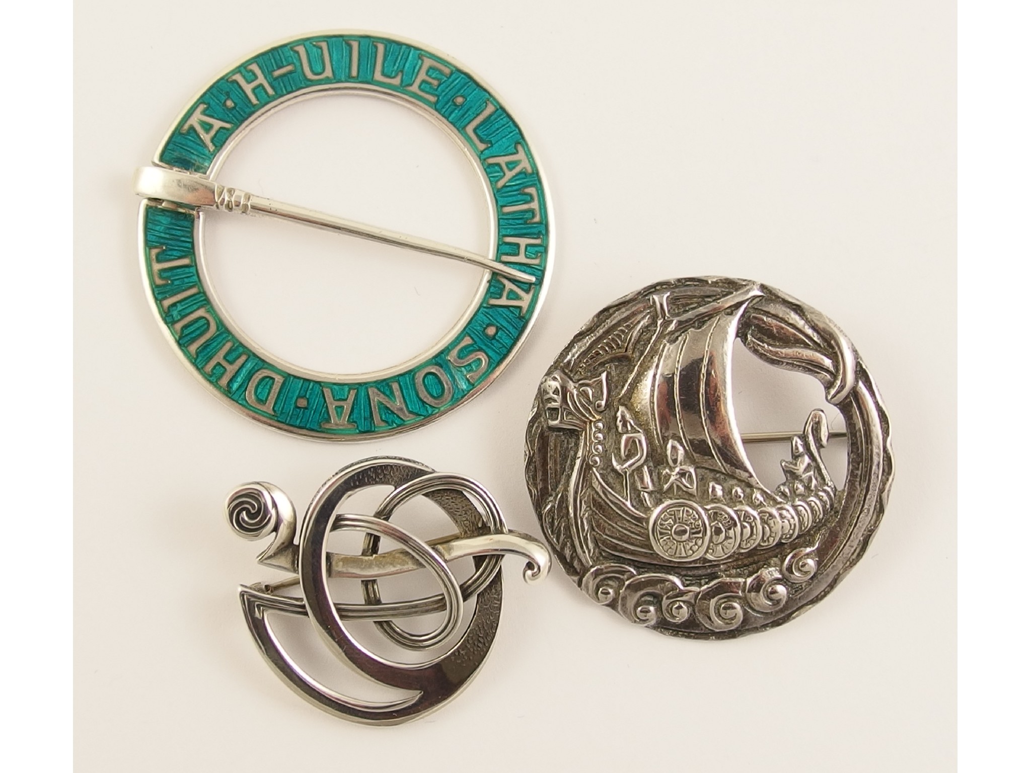 Appraisal: Three Scottish broochesa silver and turquoise green enamel annular brooch