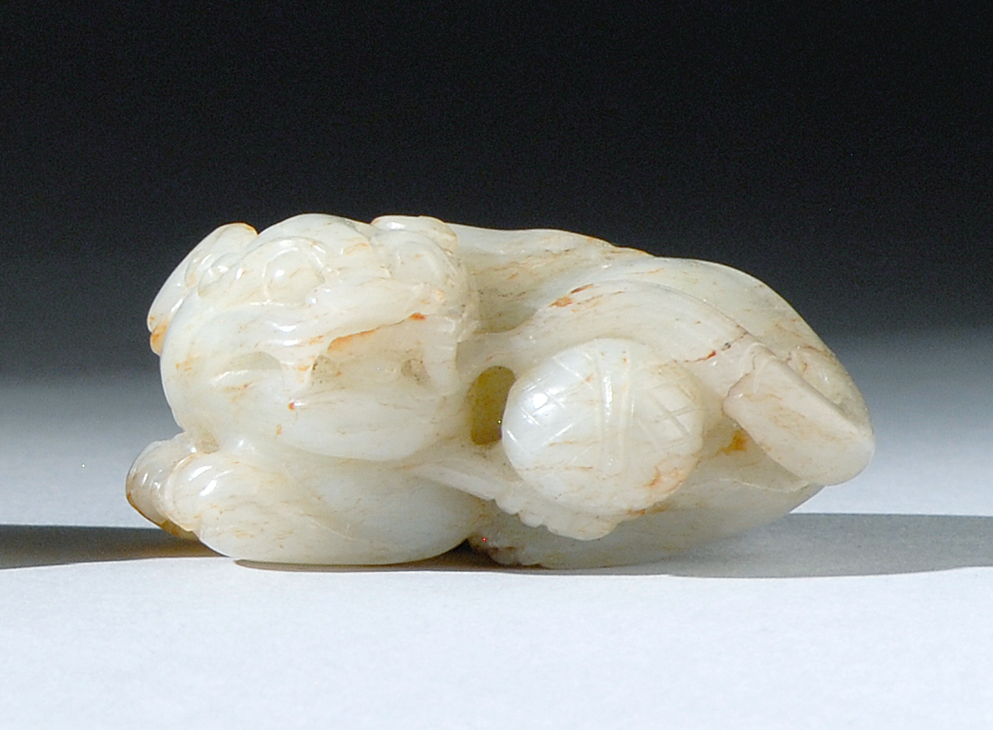 Appraisal: WHITE AND BROWN JADE CARVING th CenturyIn the form of