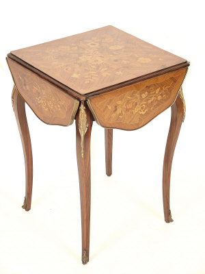 Appraisal: A French kingwood drop flap occasional table the shaped top