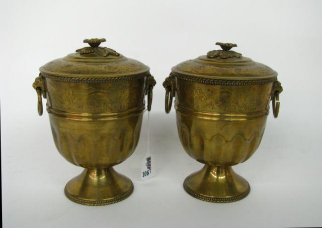 Appraisal: Pair of brass lidded urns with lions head handles and