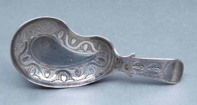 Appraisal: A GEORGE III SILVER CADDY SPOON with engraved kidney shaped