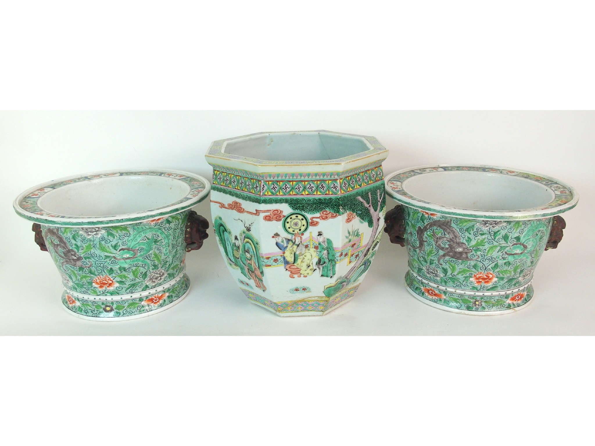 Appraisal: A pair of Chinese famille verte jardinierespainted with dragons on