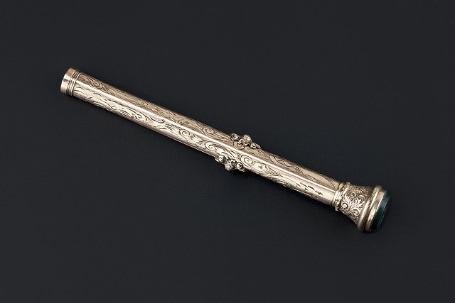 Appraisal: A gold propelling pencil of cylindrical form with foliate scroll