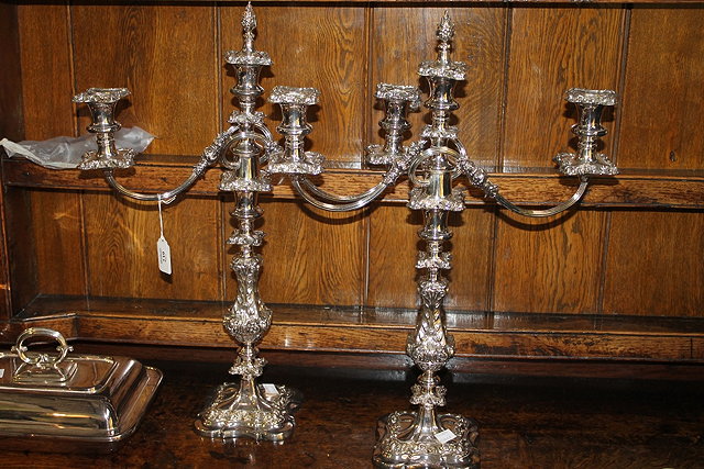 Appraisal: A PAIR OF TWO BRANCH SILVER PLATED CANDELABRA with profuse