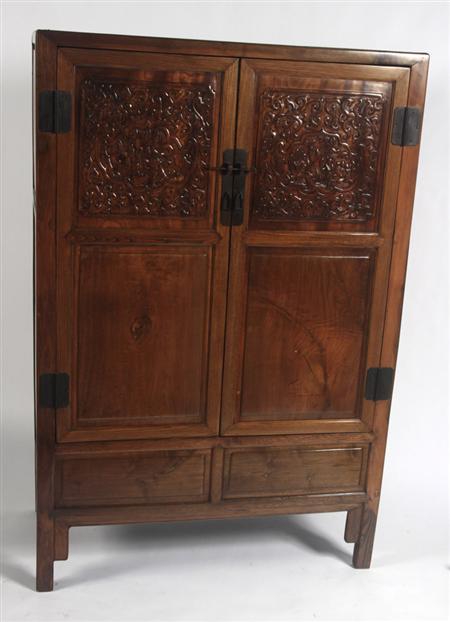 Appraisal: A th century Chinese carved softwood wardrobe with foliate carved