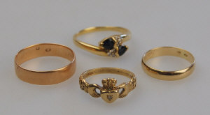 Appraisal: Four gold rings one set sapphire and diamond cross over