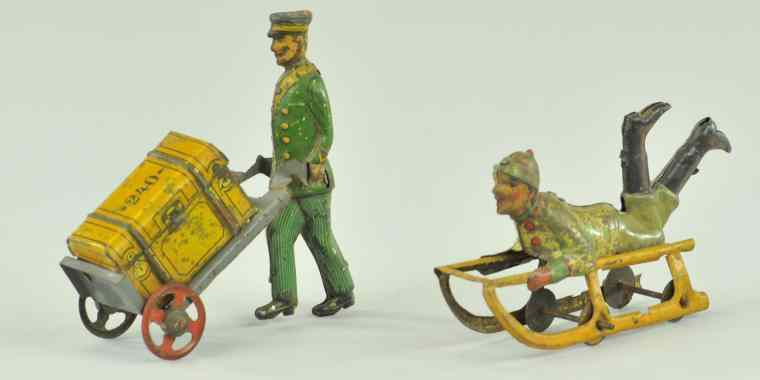 Appraisal: PORTER WITH LUGGAGE BOY ON SLED PENNY TOY Germany lithographed