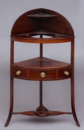 Appraisal: GEORGE III CARVED MAHOGANY CORNER WASHSTAND The bow-front top with