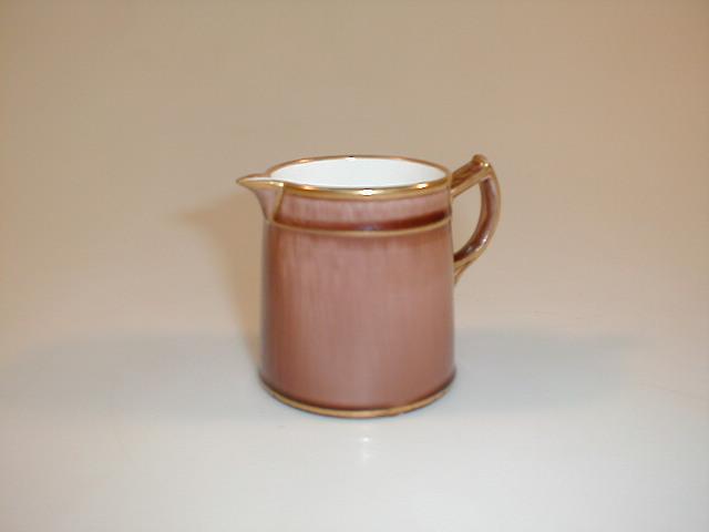 Appraisal: An Alfred Baguley cream jug of circular tapering form the