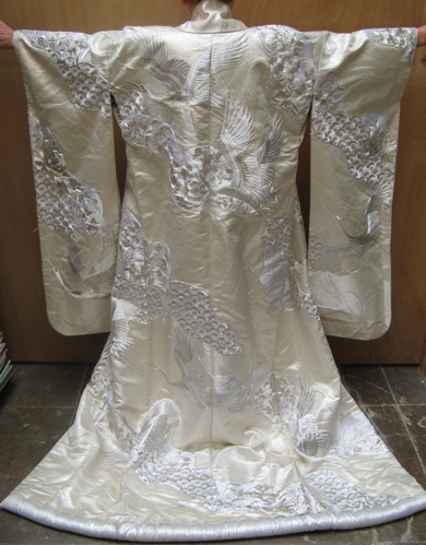 Appraisal: A JAPANESE WEDDING KIMONO in white having silver embroidered cranes