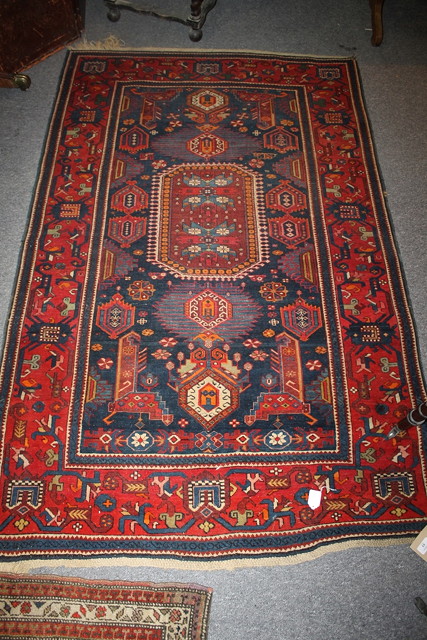 Appraisal: A TH CENTURY BLUE GROUND SHIRAZ RUG with red border