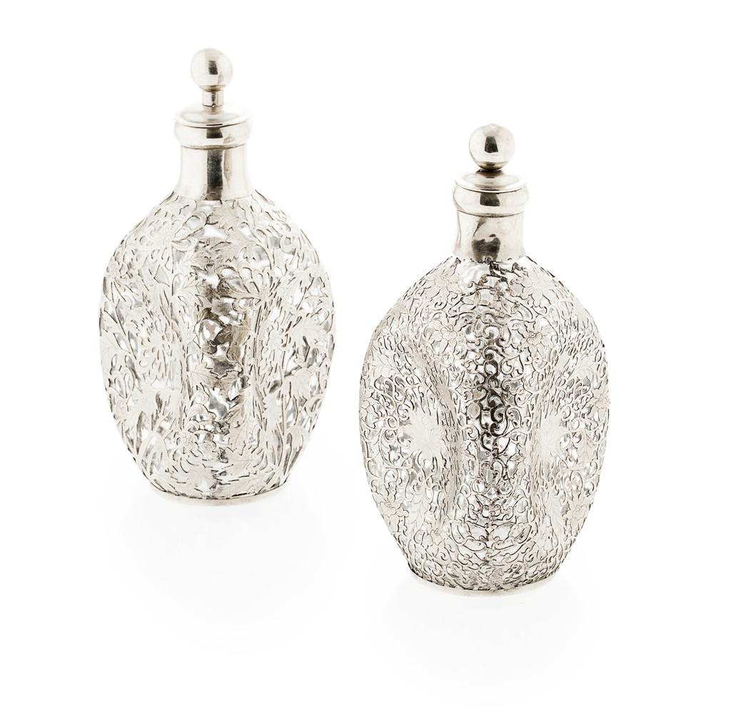 Appraisal: A matched pair of dimple Chinese silver mounted decanters marked