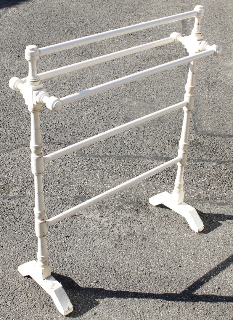 Appraisal: An Edwardian free standing towel rail painted cream with cylindrical